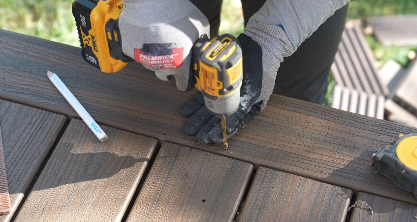 Professional deck builder installing composite deck boards in Ontario, CA